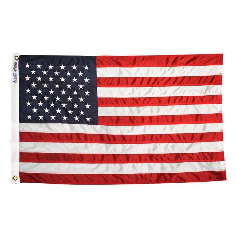 Annin USA 5'x8' Nylon-Glo Flag featuring embroidered stars and vibrant red and white stripes displayed on a flagpole outdoors.
