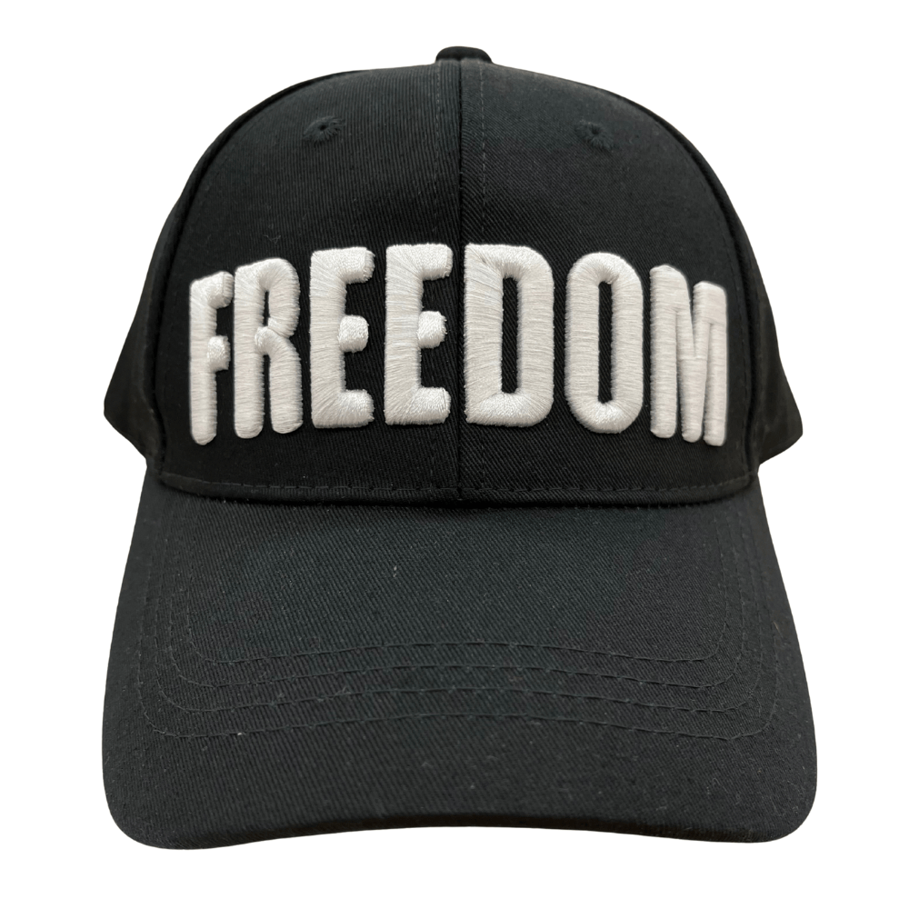 Charlie Kirk Freedom Black Hat featuring bold white 'FREEDOM' embroidery, displayed on a wooden table with a rustic background.