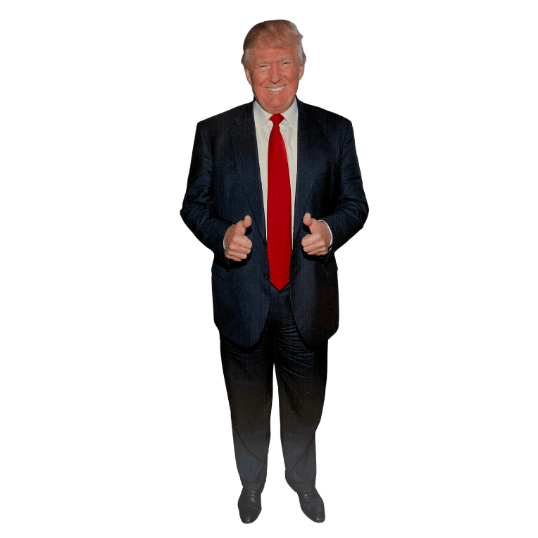 Donald Trump 12" stand-up cutout featuring double thumbs-up pose, set up on a table for display in a lively environment.