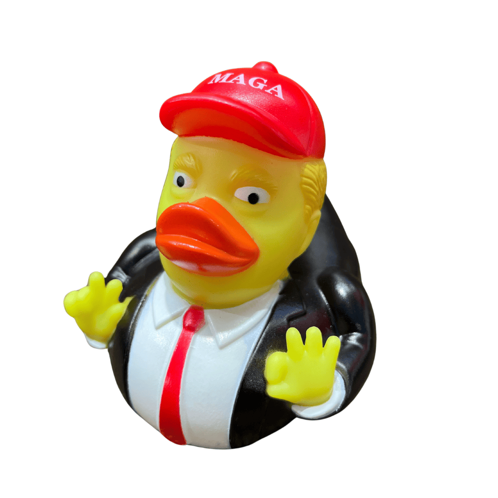 MAGA Hat Trump Duck with bright red MAGA hat and suit-and-tie design, standing on a desk with a cheerful expression.