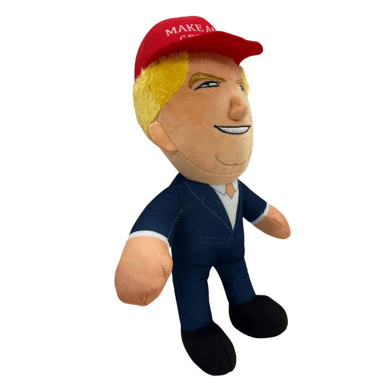 MAGA Trump Plush Doll featuring a smiling Donald Trump in a red Make America Great Again cap and navy suit, displayed on a shelf.