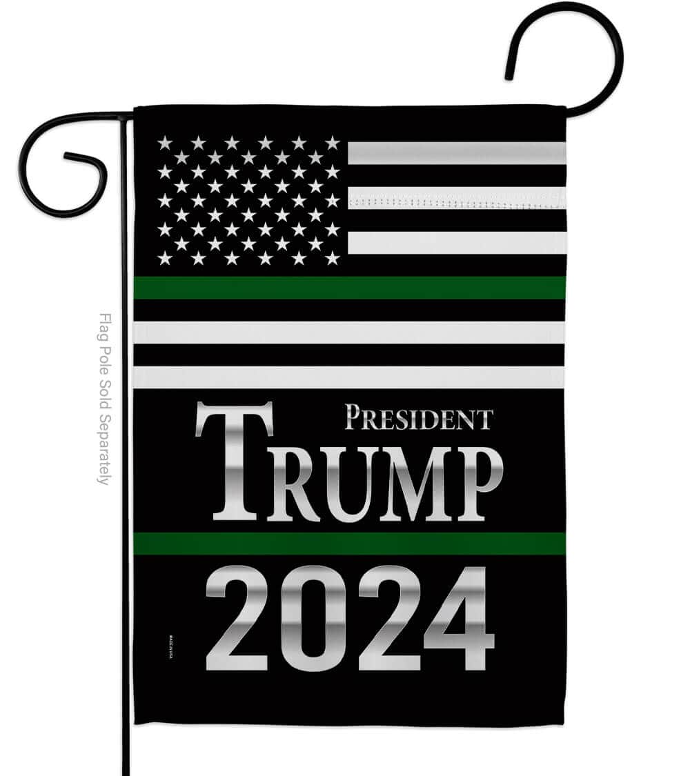President Trump Green USA Garden Flag featuring bold graphics displayed outdoors in a garden setting, showcasing patriotism and support for 2024.