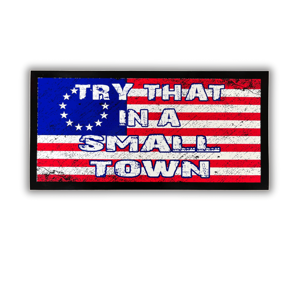 Small Town USA bumper sticker showcasing patriotic design attached to a car bumper in an outdoor setting, emphasizing American pride.