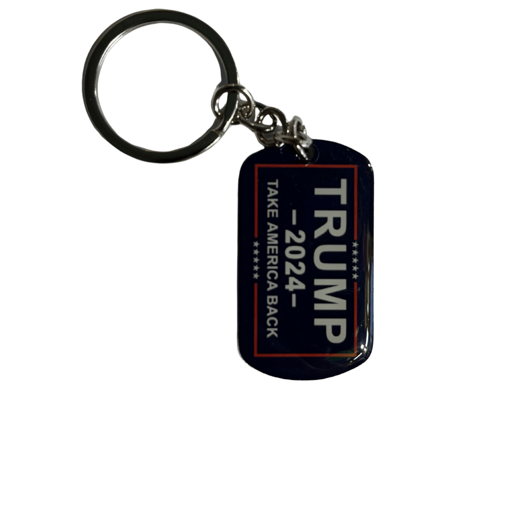 Trump 2024 Take America Back rectangle keychain featuring navy background, white lettering, and red border displayed on a wooden surface.