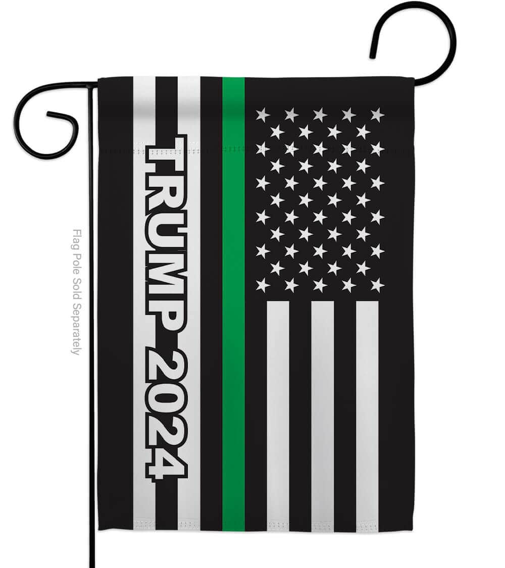 Trump 2024 Thin Green Line Garden Flag featuring vibrant colors and bold imagery displayed outdoors in a patriotic setting.