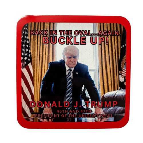 Trump Buckle Up Coaster featuring Donald J. Trump leaning over the Resolute Desk, surrounded by the American flag and a bold message displayed on a glossy surface.