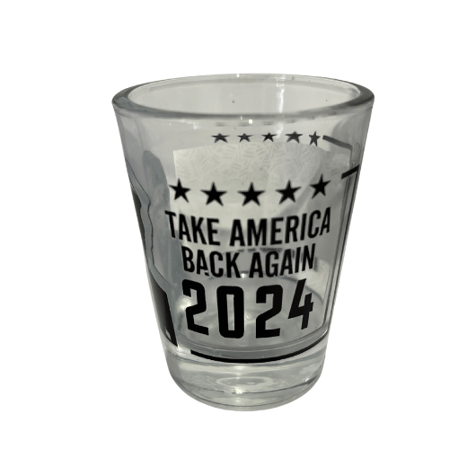 Trump Take America Back Again shot glass showcasing bold black-and-white lettering and a portrait of Donald Trump, perfect for collectibles and barware.