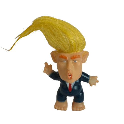 Trump Troll Hair Doll, a whimsical 3-inch collectible with bright colors and exaggerated hairstyle, displayed on a desk.