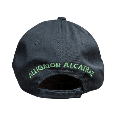 Alligator Alcatraz Black Hat featuring bold embroidered lettering and a fierce alligator artwork on the bill, displayed against a plain background.