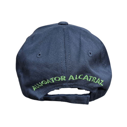 Alligator Alcatraz Navy Hat with bold green and yellow embroidery on a deep navy blue base, featuring a colorful illustration of an alligator on the bill.