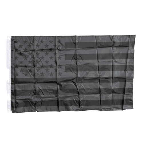 Blackout Traditional USA 3x5 Flag displaying the Stars and Stripes with a unique blackout design, mounted on a flagpole in an outdoor setting.