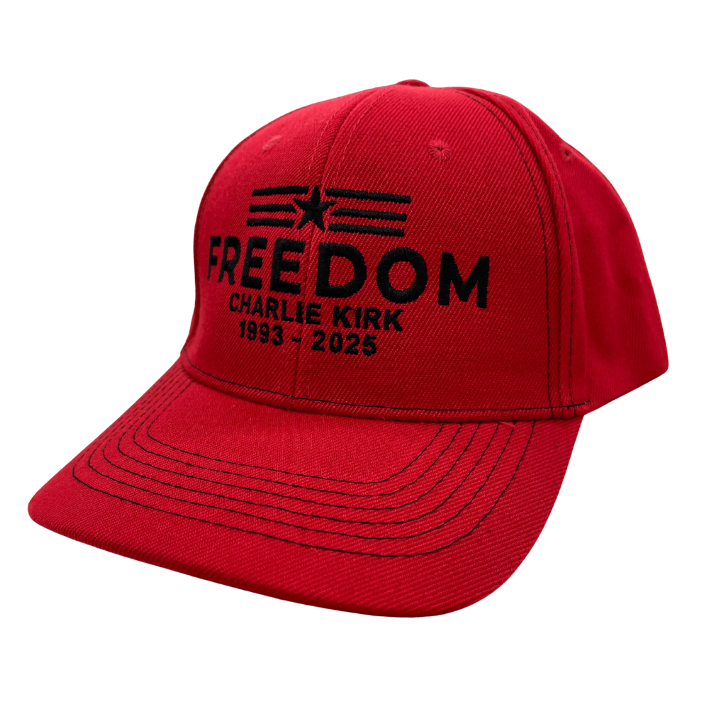 Charlie Kirk Freedom Star Red Hat featuring black embroidered 'FREEDOM' text and star-stripe emblem on a red cotton twill background.