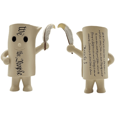 The Constitution Pocket Patriot figurine, 4.25 inches tall, depicting a personified scroll holding a feather quill, displayed on a shelf.