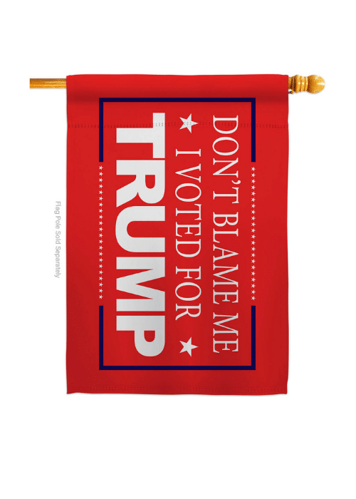 Don't Blame Me, I Voted for Trump! double-sided red house flag displayed on a flag pole in a yard, featuring bold political text.
