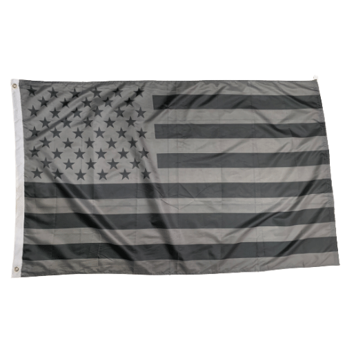Grey USA 3x5 flag featuring white stars and stripes, displayed on an outdoor flagpole against a clear blue sky.