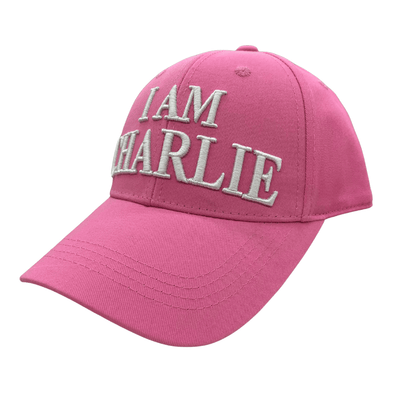 I Am Charlie Pink Hat featuring bold white embroidery, 'I AM CHARLIE' on the front and 'CHARLIE KIRK' on the back, displayed outdoors.
