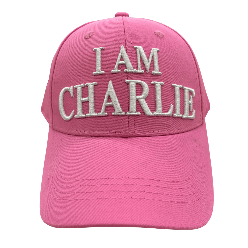 I Am Charlie Pink Hat featuring bold white embroidery, 'I AM CHARLIE' on the front and 'CHARLIE KIRK' on the back, displayed outdoors.