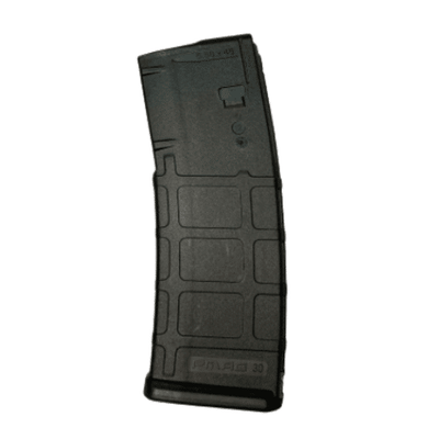 Let's Go Brandon 5.56 30-Round PMAG featuring a playful custom print, displayed alongside a firearm on a shooting range.