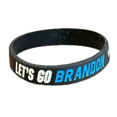 Black rubber bracelet featuring the phrase 'Let's Go Brandon!' displayed on a hand, showcasing support for the movement.