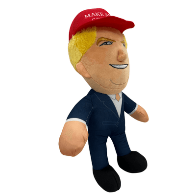MAGA Trump Plush Doll featuring a smiling Donald Trump in a red Make America Great Again cap and navy suit, displayed on a shelf.