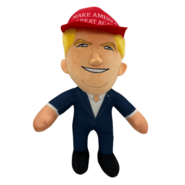 MAGA Trump Plush Doll featuring a smiling Donald Trump in a red Make America Great Again cap and navy suit, displayed on a shelf.