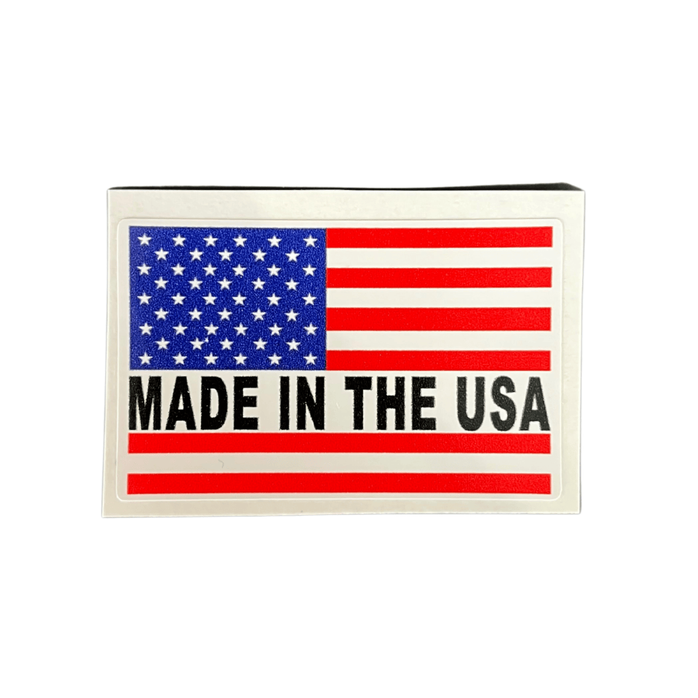 Patriotic Made In The USA Sticker featuring bold designs, applied on a white laptop with an outdoor background.