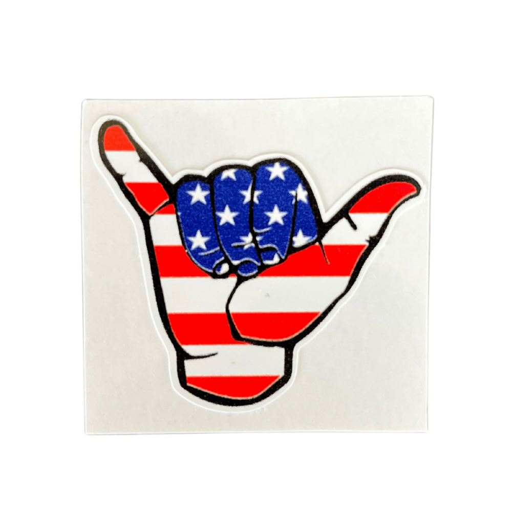 Patriotic Shaka Sticker featuring bold American themes, displayed on a laptop, showcasing its vibrant color and design.