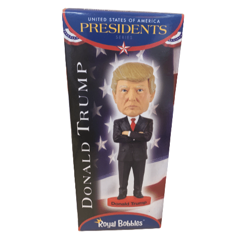 President Trump Royal Bobblehead showcasing a smiling Trump with a red tie, bobbling on a sturdy base in an office setting.