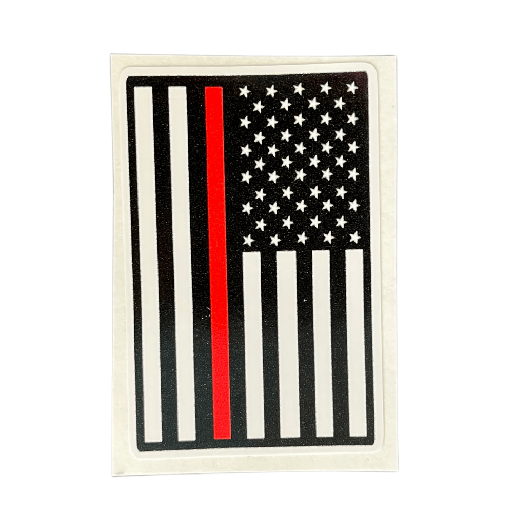 Thin Red Line Sticker featuring a bold red line on a black background, displayed on a laptop in an outdoor setting.