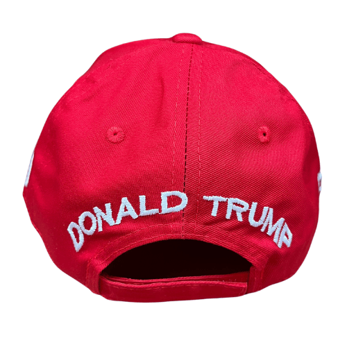 The Trump 2.0 Red Hat featuring bold white embroidery and American flag detail, worn in an outdoor setting to showcase patriotism.