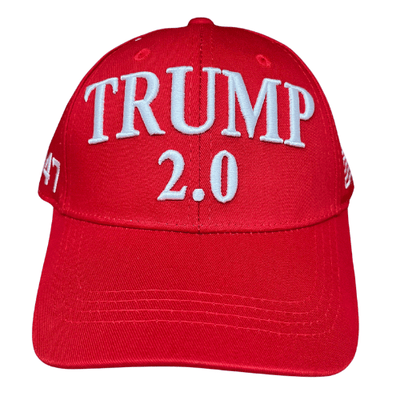 The Trump 2.0 Red Hat featuring bold white embroidery and American flag detail, worn in an outdoor setting to showcase patriotism.
