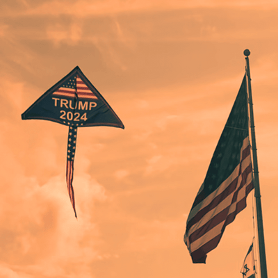 Trump 2024 Kite displaying patriotic colors, measuring 32x55 inches with a long tail flying high against a bright blue sky.