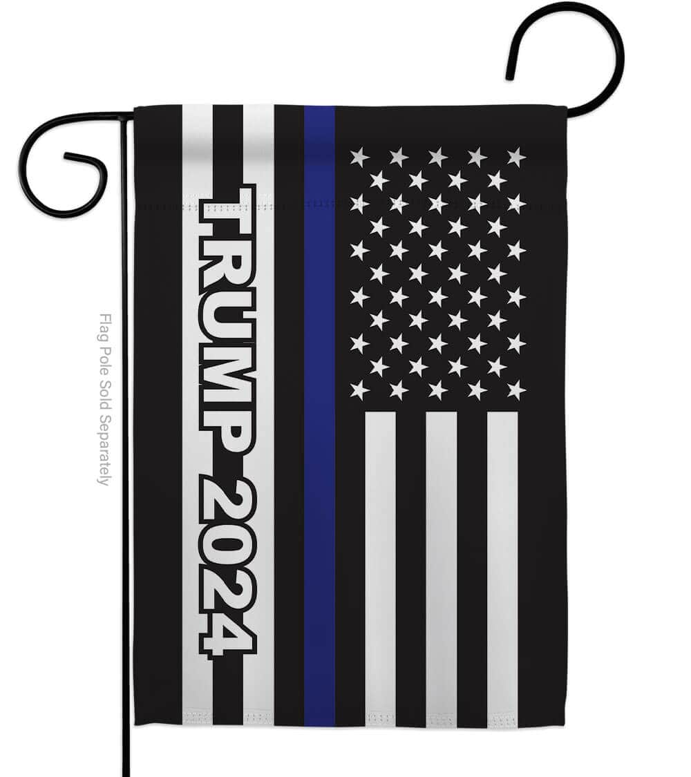 Trump 2024 Thin Blue Line garden flag featuring a blue line against the American flag, displayed on a pole in a garden setting.
