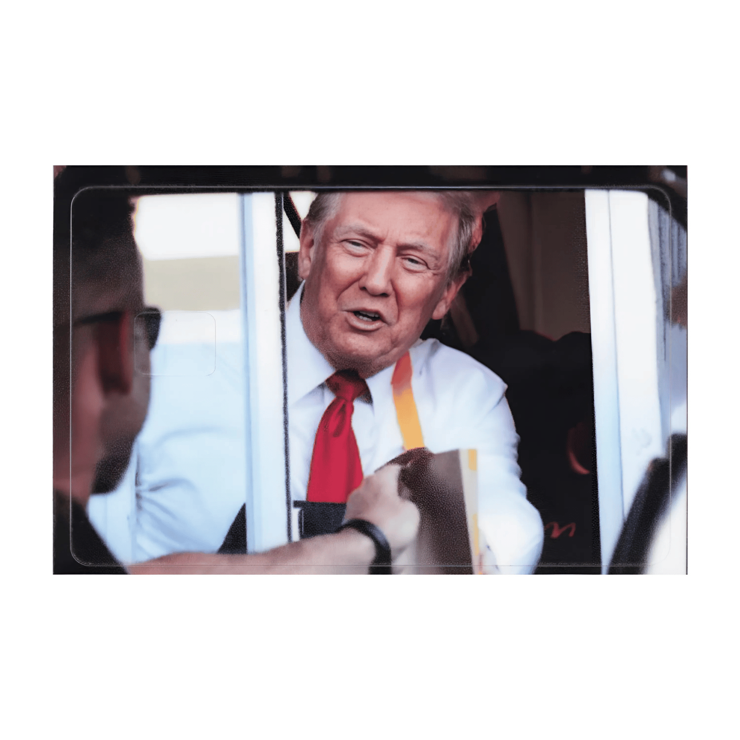 Trump Drive-Thru Credit Card Cover featuring Donald Trump at a drive-thru window, designed with vibrant colors and a smooth finish.