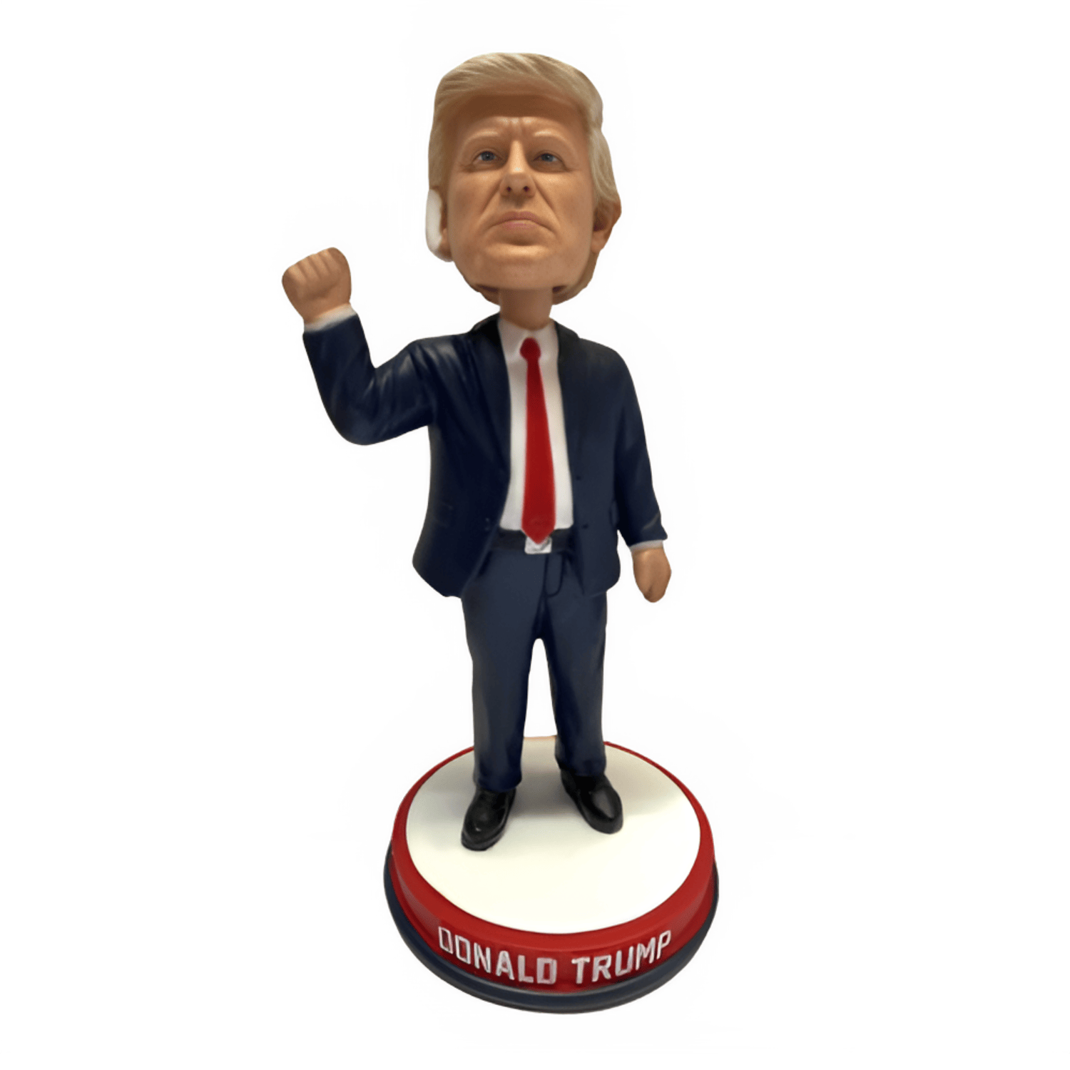 Trump Fist Pump Bandage Bobble Head featuring Donald Trump with a bloodied ear and a raised fist on a red, white, and blue base.