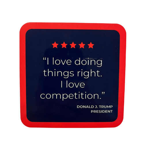 Motivational Trump I Love Competition Coaster with navy background, red border, and bold quote displayed on a wooden table.