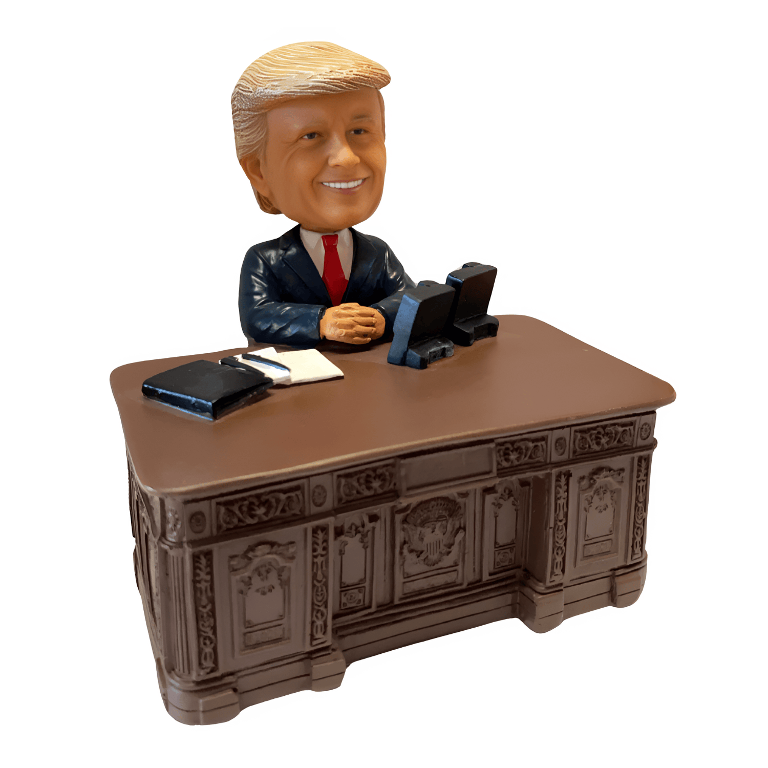 Trump Resolute Desk Bobble Head collectible figurine, depicting former President Trump seated at the historic Resolute Desk, showcasing intricate details.
