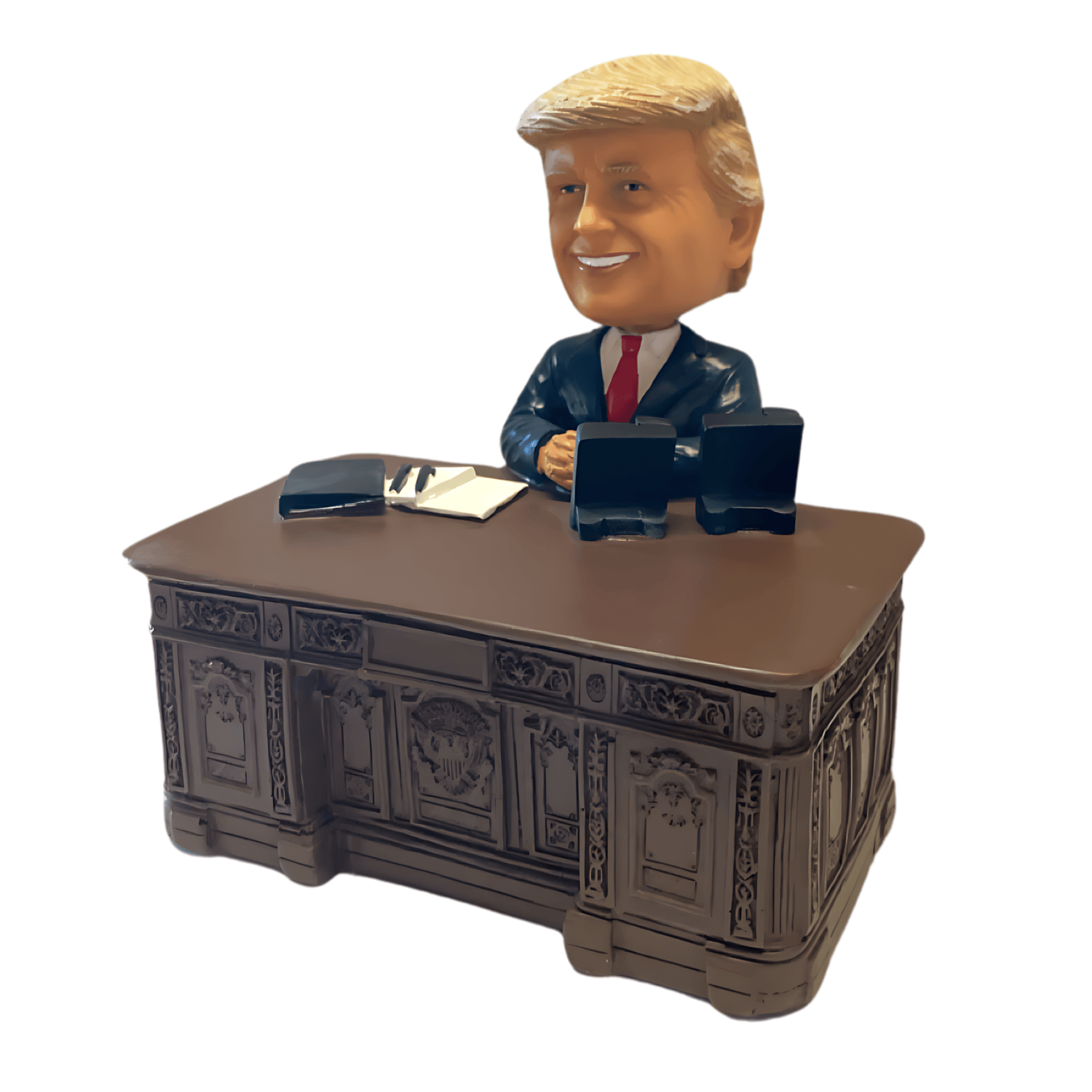 Trump Resolute Desk Bobble Head collectible figurine, depicting former President Trump seated at the historic Resolute Desk, showcasing intricate details.