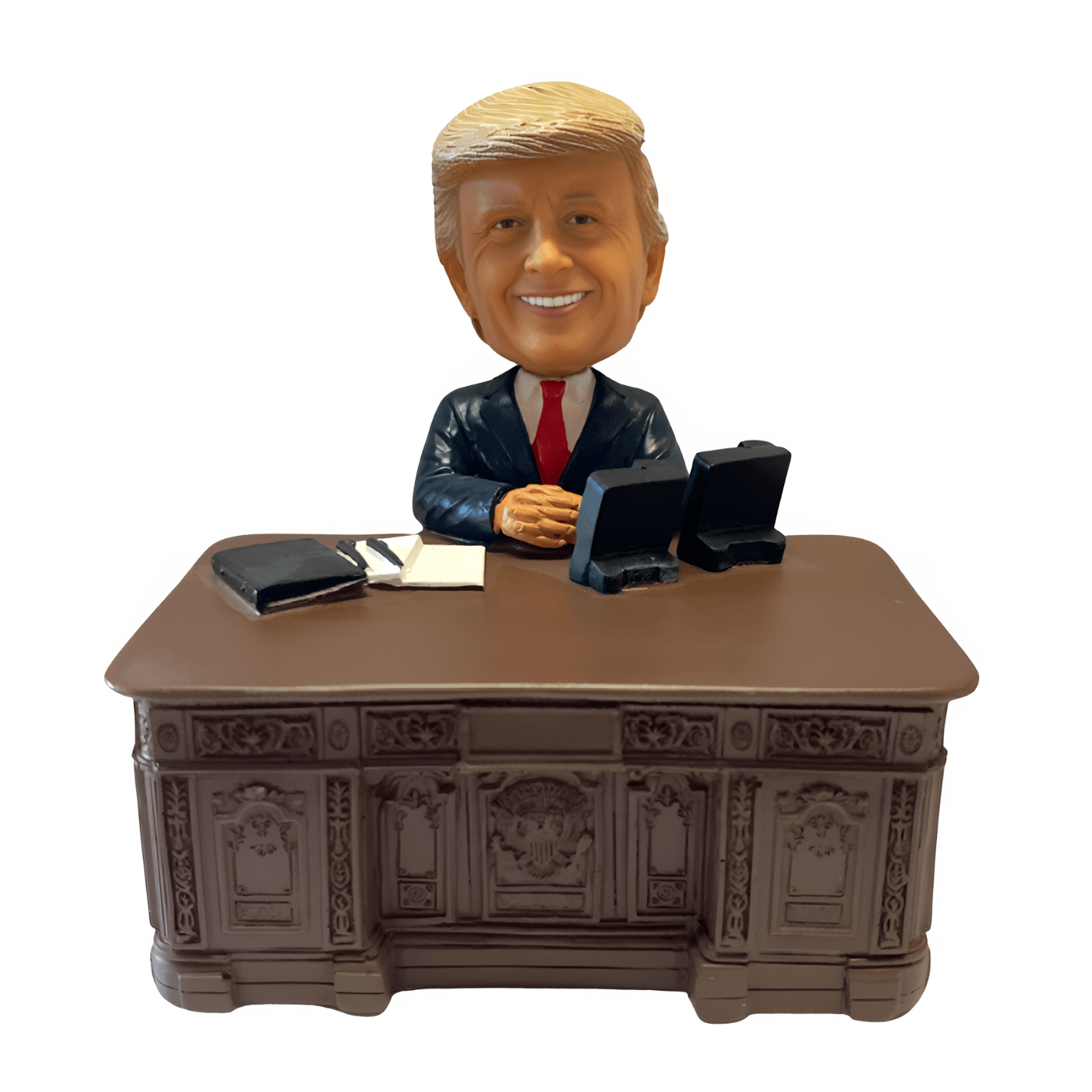 Trump Resolute Desk Bobble Head collectible figurine, depicting former President Trump seated at the historic Resolute Desk, showcasing intricate details.