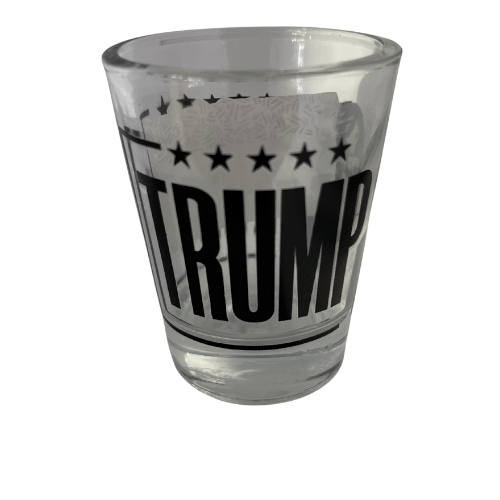 Trump Take America Back Again shot glass showcasing bold black-and-white lettering and a portrait of Donald Trump, perfect for collectibles and barware.
