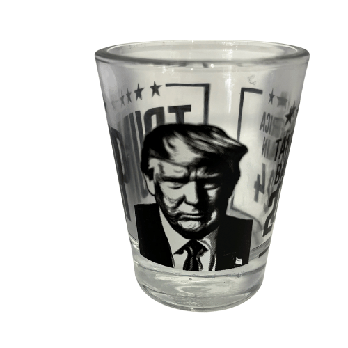 Trump Take America Back Again shot glass showcasing bold black-and-white lettering and a portrait of Donald Trump, perfect for collectibles and barware.