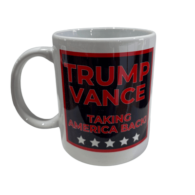 Trump Vance 2024 'Taking America Back!' Mug featuring bold red text and stars displayed on a kitchen table with coffee inside.