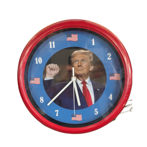 Trump Wall Clock featuring a vibrant blue background, an image of Donald J. Trump, and American flag accents displayed on a wall.
