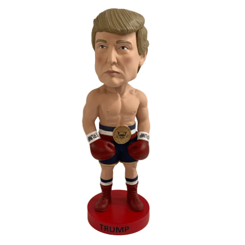Trump World Champ Boxer Bobblehead displaying Trump in a boxing stance with detailed features and bright colors on a shelf background.