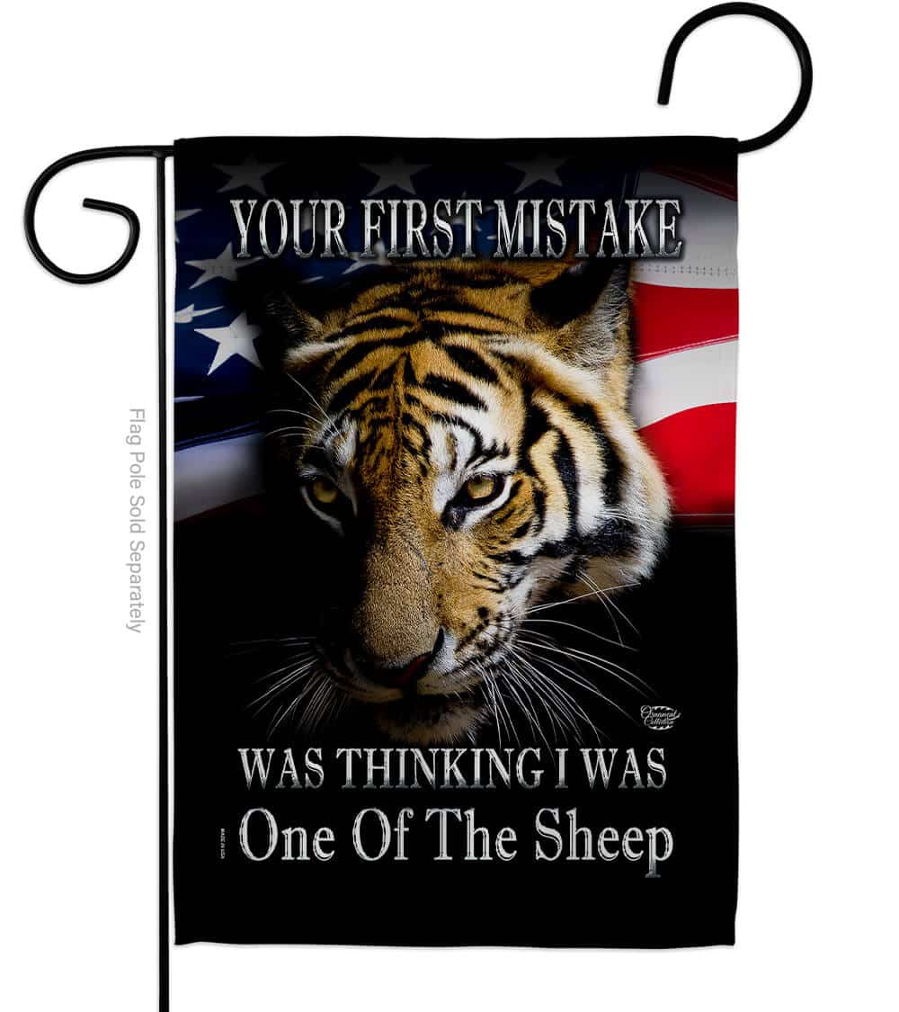 Your First Mistake double-sided garden flag featuring a bold design, proudly displayed on a garden pole in a yard setting.