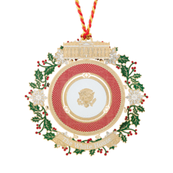 Elegant 2025 Presidential China Ornament — 3" brass collectible finished in 24K gold, featuring a detailed china plate design with holly and snowflake accents, presented in a keepsake gift box.